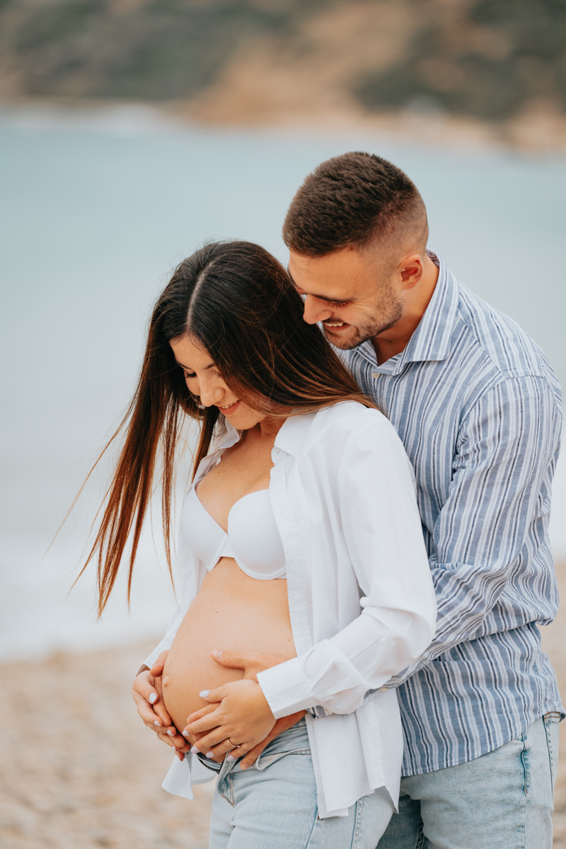 Servizio fotografico gravidanza a Mari Pintau con cielo nuvoloso e luce morbida sul mare